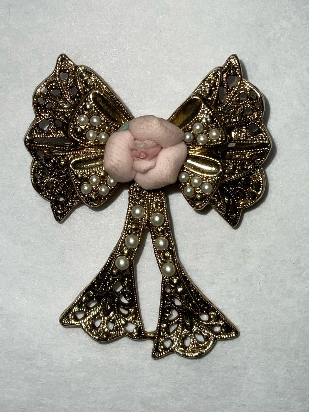 1928 Brand Gold Tone Filigree Bow and Porcelain Rose Brooch